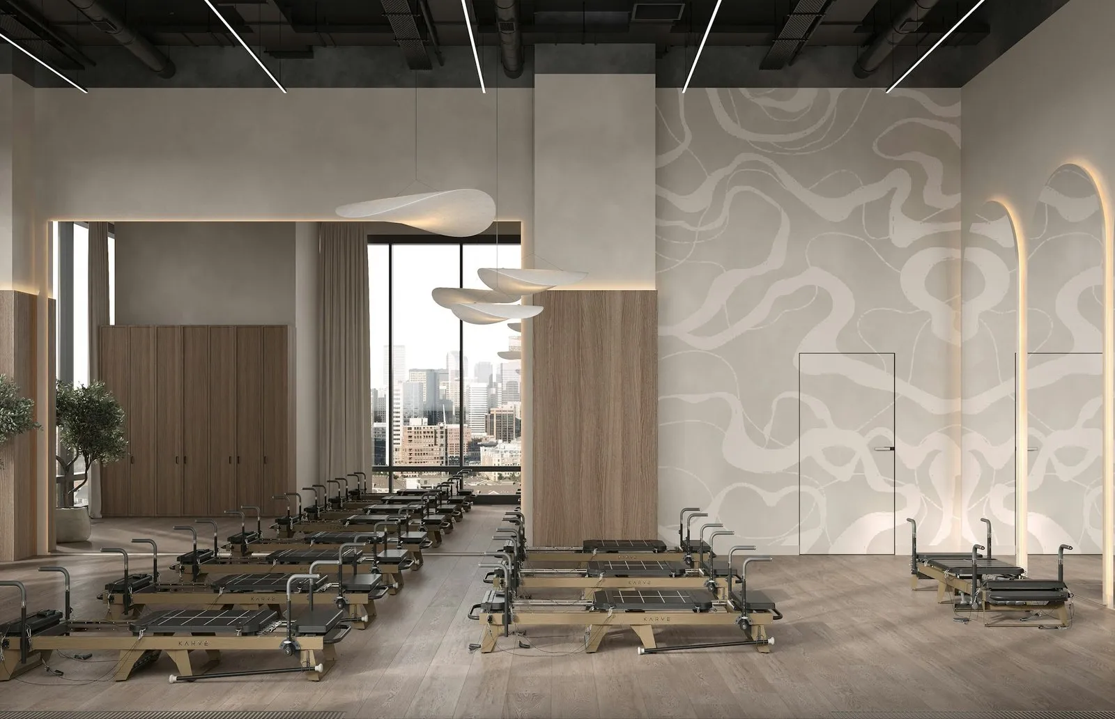 A calm studio with wooden reformers in a row under a tall window
